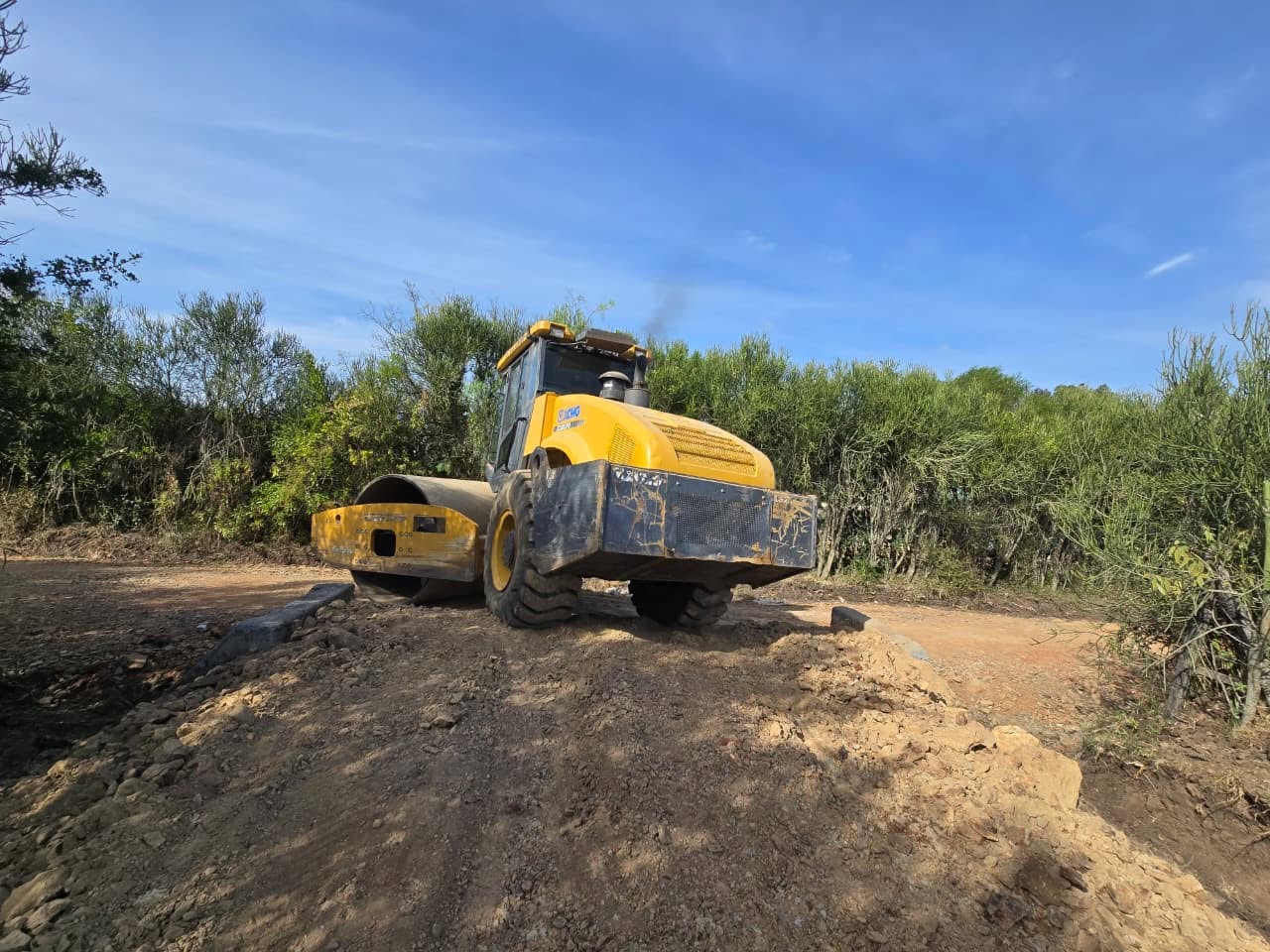 Road roller compacting a newly paved estate road