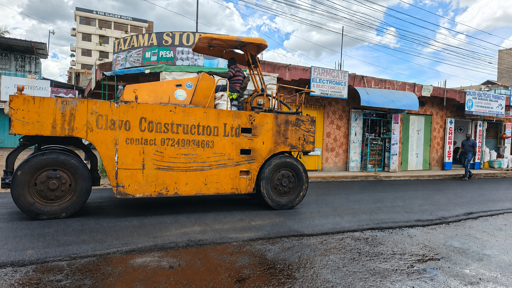 Road construction roller working on a paved road